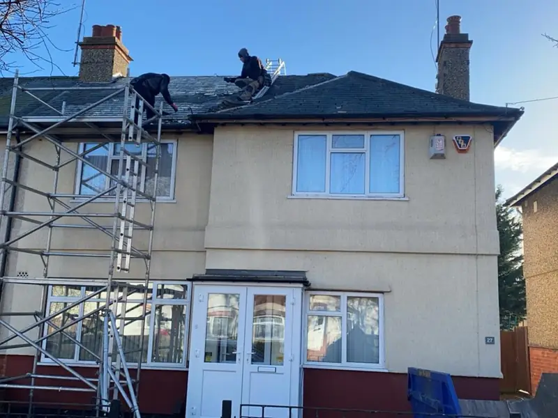 Roofers at work on a family home