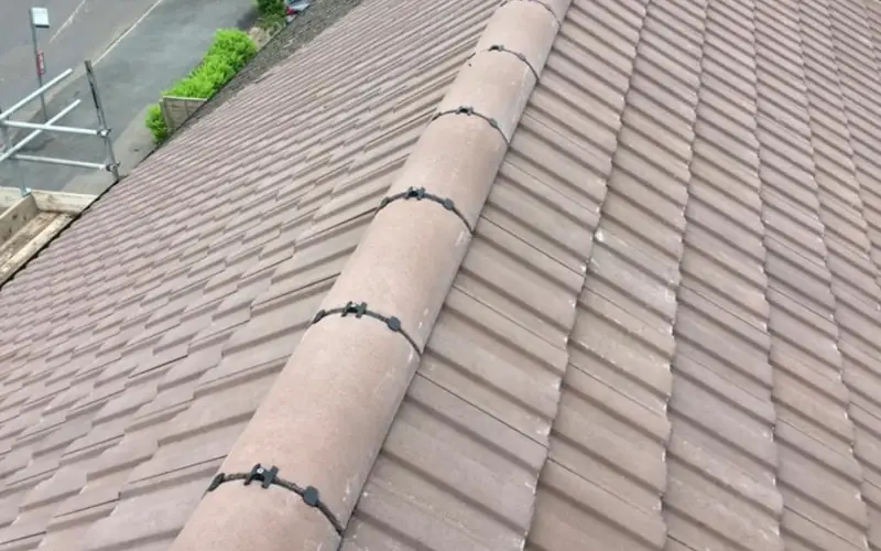 Ridge tiles re-bedded along a pitched roof